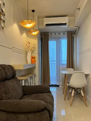 a living room with a couch and a table at Twin Duckworth Suites T3 in Manila