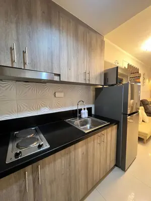a kitchen with a sink and a refrigerator at Twin Duckworth Suites T3 in Manila
