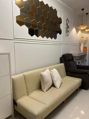 a living room with a couch and a chair at Twin Duckworth Suites T3 in Manila