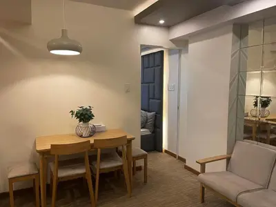 a dining room with a table and chairs at KYH STAYCATION 2BR by Azure Residences Near Airport in Manila