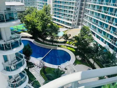 an overhead view of a pool in a city with tall buildings at KYH STAYCATION 2BR by Azure Residences Near Airport in Manila