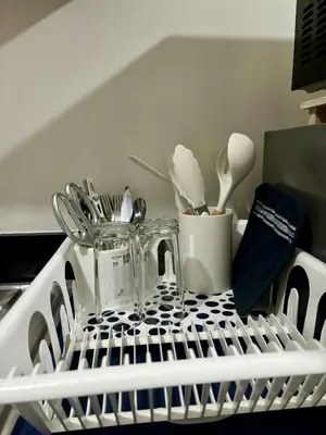 a dish drying rack with utensils in a kitchen at New Oasis Staycation Shore 2 in Manila
