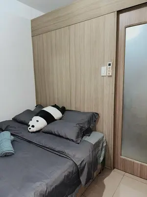a bed with a stuffed animal laying on top of it at 1BR Shore Residences near Mall Of Asia in Manila