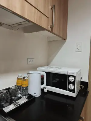 a microwave sitting on a counter in a kitchen at 1BR Shore Residences near Mall Of Asia in Manila