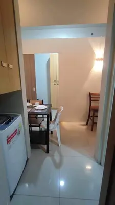 a kitchen and dining room with a table and chairs at Mall of Asia Garden view 2 Bedrooms 2 bathrooms in Manila
