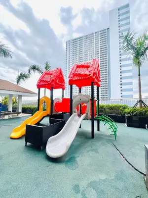 a playground at a resort with a slide at Stunning Suite with Balcony near MOA in Manila