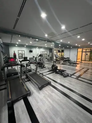 a gym with several treadmills and exercise machines at Studio Unit McKinley Hill Taguig cd21H in Manila