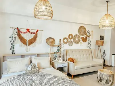 a bedroom with a white bed and a couch at Venice Luxury Residences Studio McKinley Hill in Manila
