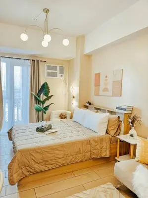 a bedroom with a large bed and a couch at Venice Luxury Residences Studio Taguig City in Manila