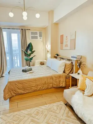 a bedroom with a large bed and a couch at Venice Luxury Residences Studio Taguig City in Manila