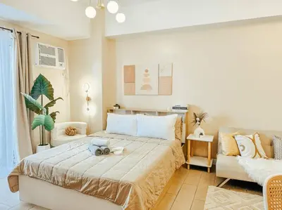 a bedroom with a large bed and a couch at Venice Luxury Residences Studio Taguig City in Manila