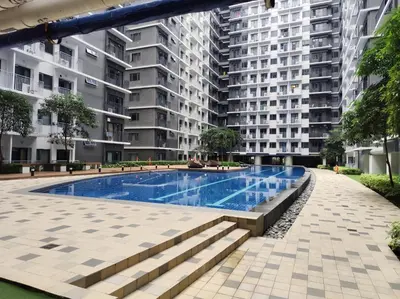 an empty swimming pool in an apartment building at Callie's Cozy Home at Shore 3 Mall of Asia in Manila