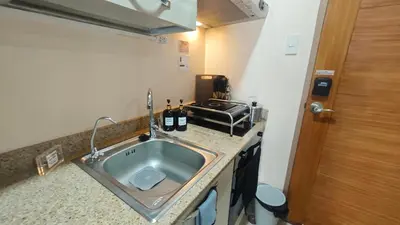 a small kitchen with a sink in a room at Casa Prian in Manila