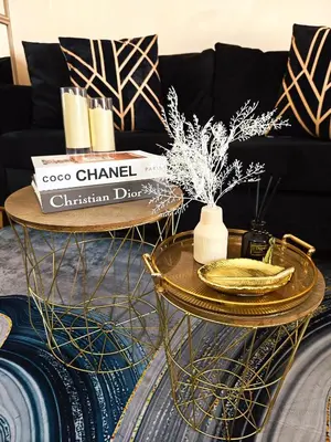 a living room with a gold coffee table and a black couch at Casa Prian in Manila
