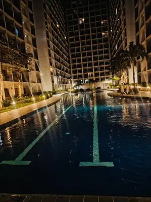 a large pool in the middle of a building at Candid Suite by ARL in Manila