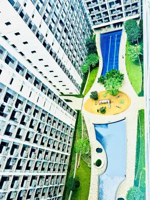 an overhead view of an apartment building with a swimming pool at Candid Suite by ARL in Manila