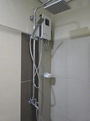a shower in a bathroom with a shower head at 1554 Apartel Breeze Resident in Manila