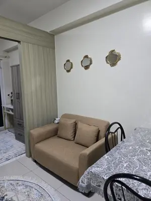 a living room with a couch and a table at 1554 Apartel Breeze Resident in Manila