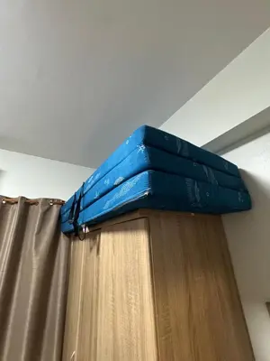 a blue umbrella is on top of a curtain at M&M Condostay at Shore 2 Residences Tower 2 in Manila