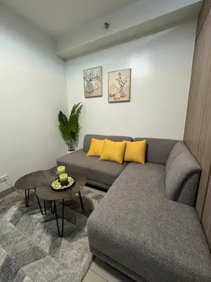 a living room with a couch and a table at M&M Condostay at Shore 2 Residences Tower 2 in Manila