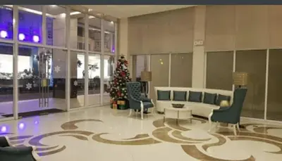 a living room with a christmas tree in a building at Ivy Condotels unit-150 Newport Boulevard near terminal 3 and all Airport in Manila