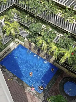 an overhead view of a swimming pool with people in it at Ivy Condotels unit-150 Newport Boulevard near terminal 3 and all Airport in Manila