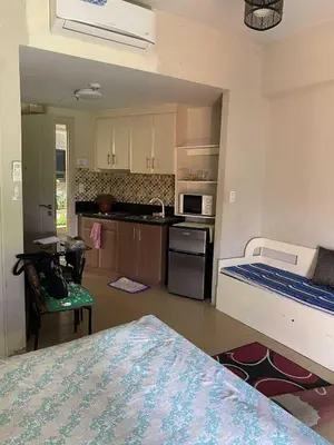 a room with a kitchen with a bed and a kitchen at Ivy Condotels unit-150 Newport Boulevard near terminal 3 and all Airport in Manila