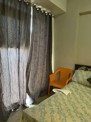 a bedroom with a bed and a window with curtains at Ivy Condotels unit-150 Newport Boulevard near terminal 3 and all Airport in Manila