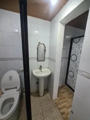 a small bathroom with a toilet and a sink at Js Guest House in Imus