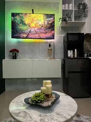a table in a kitchen with a plate of candles at Evergreen suite- 1 bed 1 sofa bed, light sync TV in Manila