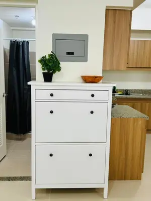 a white dresser with a microwave on top of it in a kitchen at FAIRLANE residences in Manila