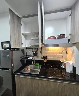 a kitchen with a sink and a counter top at Coast Residences - 1 Bedroom with Balcony near PICC, WTC, Star City & MOA in Manila