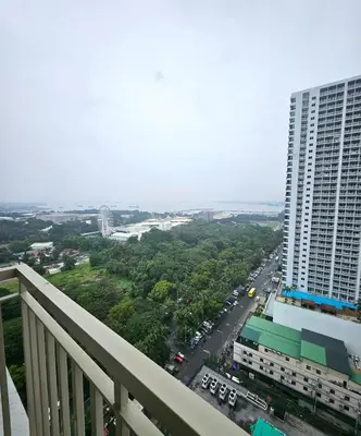 a view of a city from a balcony of a building at Coast Residences - 1 Bedroom with Balcony near PICC, WTC, Star City & MOA in Manila