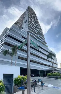 a street sign in front of a tall building at Coast Residences - 1 Bedroom with Balcony near PICC, WTC, Star City & MOA in Manila