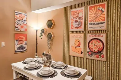 a dining room with a table with dishes on it at Spacious Pool View 2br 2bath Apt in Makati in Manila