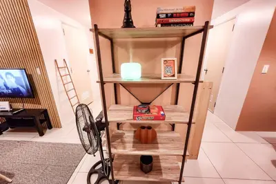 a shelf in a room with a candle and a pumpkin at Spacious Pool View 2br 2bath Apt in Makati in Manila