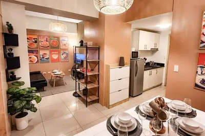 a kitchen with a table with plates on it at Spacious Pool View 2br 2bath Apt in Makati in Manila