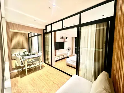 a hotel room with a bedroom and a bed and a desk at Novotel Residential Tower at Acqua Private Residences Mandaluyong - Makati in Manila
