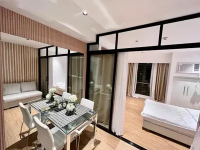 a living room with a table and a couch at Novotel Residential Tower at Acqua Private Residences Mandaluyong - Makati in Manila