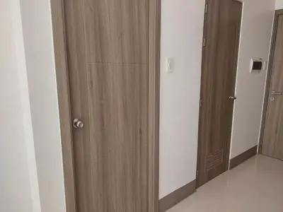 a room with two wooden closets in a room at FAME Bedroom in Manila