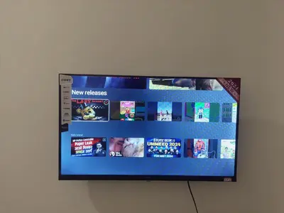 a flat screen tv hanging on a wall at FAME Bedroom in Manila