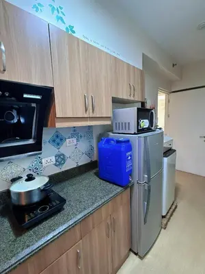 a kitchen with a refrigerator and a microwave at Torre De Manila in Manila