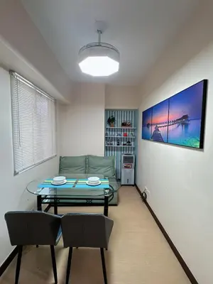 a living room with a couch and a table at Torre De Manila in Manila