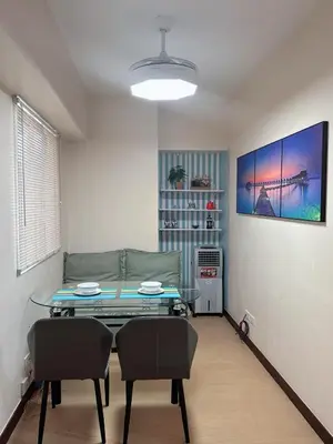 a living room with a table and a couch at Torre De Manila in Manila