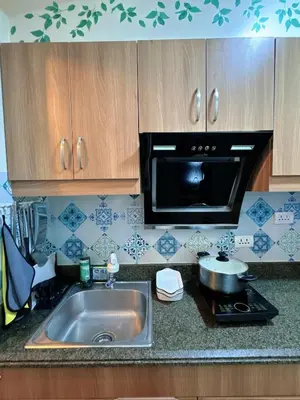 a kitchen with a sink and a microwave at Torre De Manila in Manila