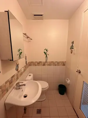 a bathroom with a sink and a toilet at Torre De Manila in Manila