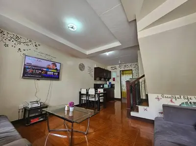 a living room with a couch and a table at Alohas House in Cupang