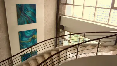 a staircase in a building with a painting on the wall at SMDC Coast Residences in Manila