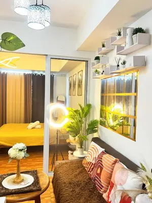 a living room with a bed and a couch at Mhax's Place - Azure Parañaque in Manila