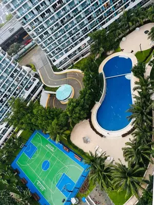 an aerial view of a large apartment building and a swimming pool at Mhax's Place - Azure Parañaque in Manila